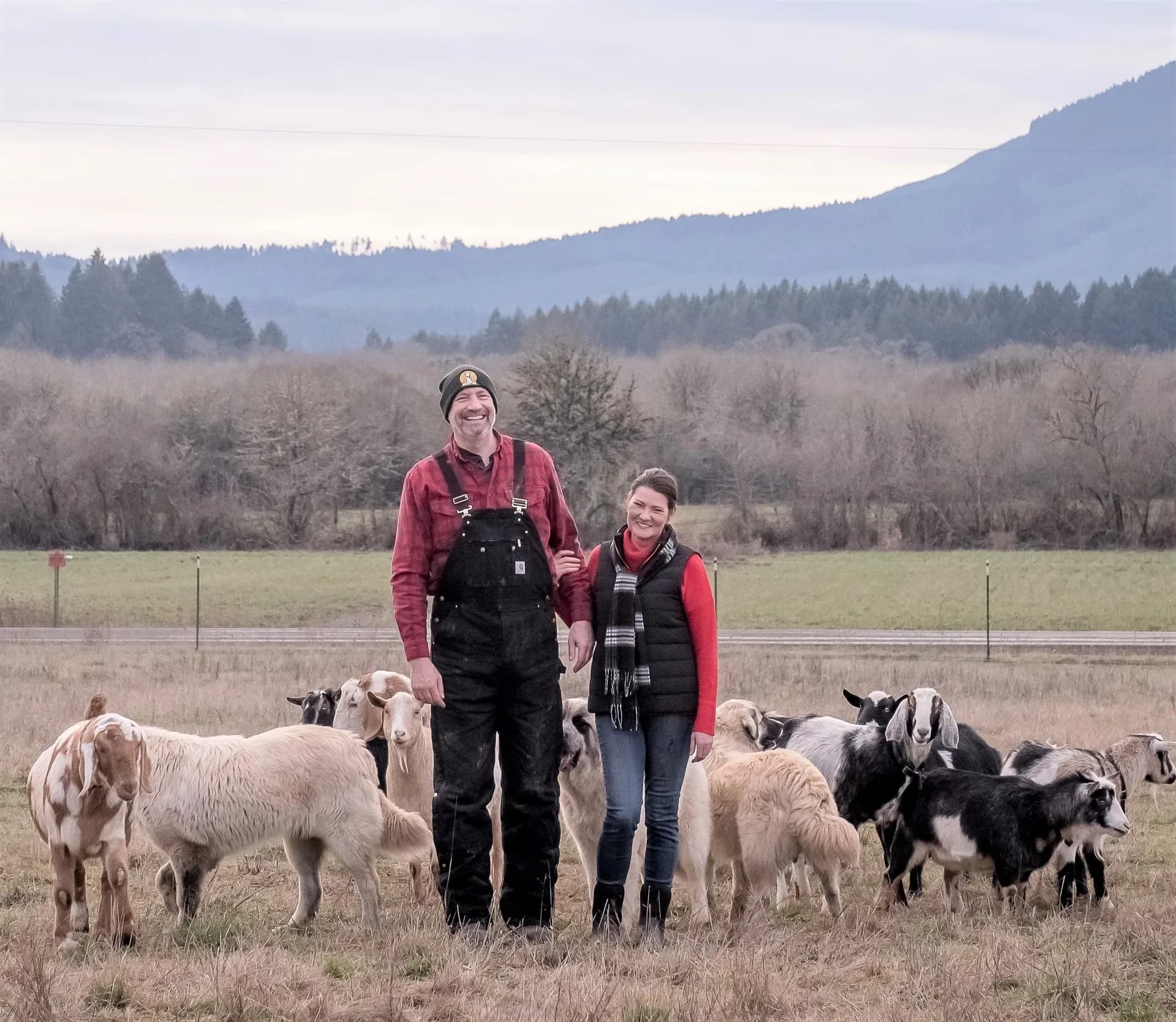 Lainey Morse and Sean Scorvo with their goats at No Regrets Flower Farm & Animal Sanctuary